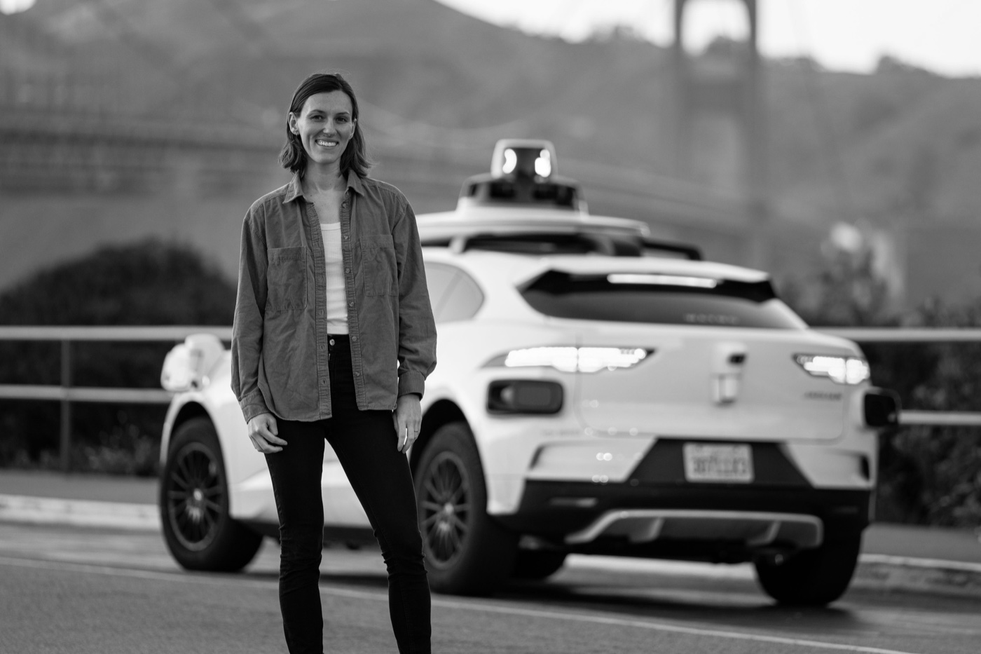 Brooke Hopkins standing in front of a Waymo vehicle
